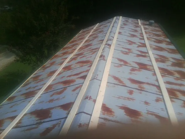 Rusted metal roof panels with new wood purlins before replacement — Storm Damage Roof Repair in Ontario by Roofing Brothers